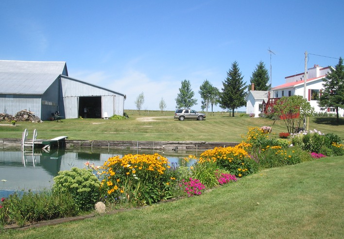 Pond view of Barn and House